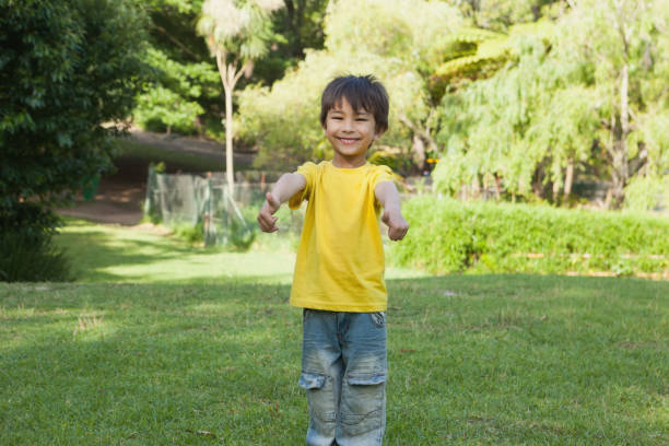 istock Young boy gesturing thumbs up in park 692371484