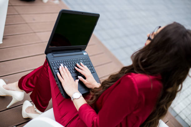 istock Woman outdoors in park with laptop 692378490