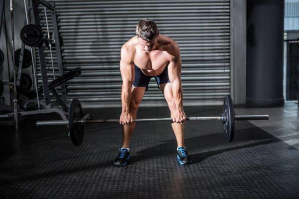 istock Muscular man lifting a barbell 692379380