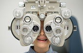 Young patient getting an eye exam at the optician
