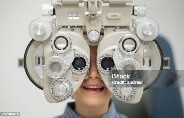 Young Patient Getting An Eye Exam At The Optician Stock Photo - Download Image Now - Child, Myopia, Optometrist