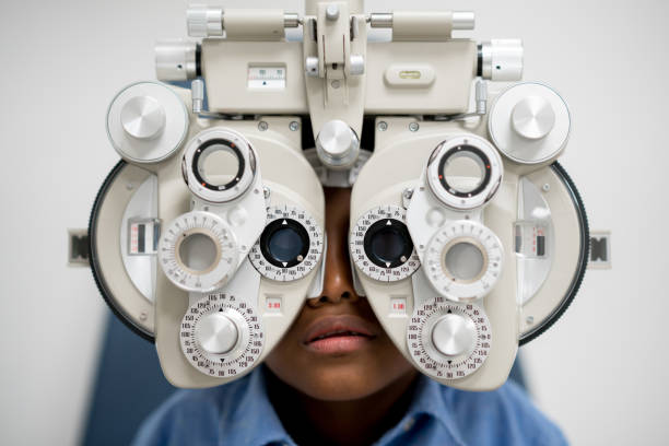 istock Boy getting an eye exam at the optician 692381766