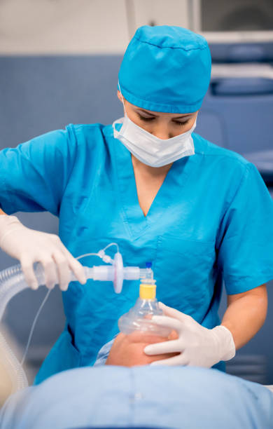 istock Doctor putting oxygen mask to patient during surgery 692381872