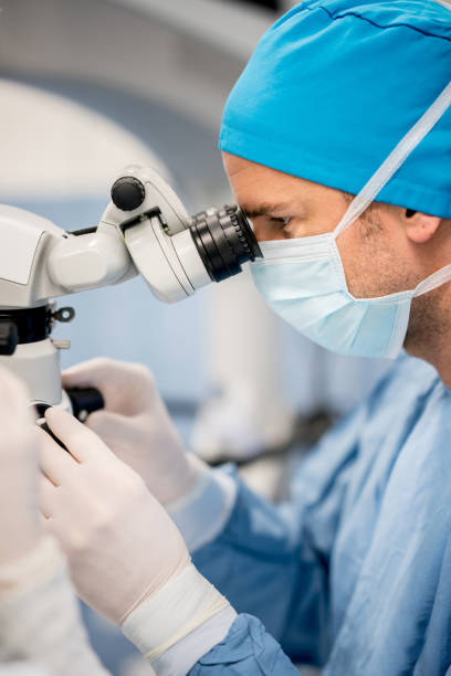 istock Ophthalmic surgeon performing an eye surgery under the microscope 692381880