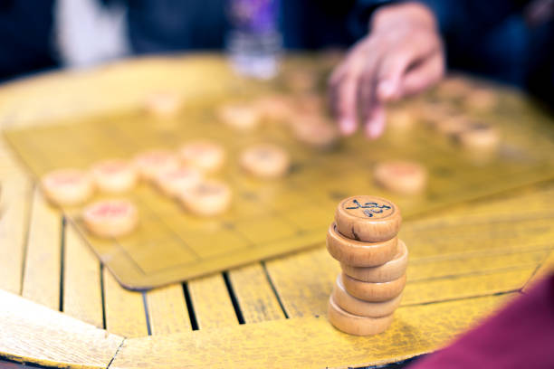 istock people playing chinese chess in park 692396720