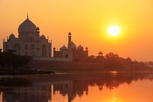 istock Taj Mahal reflected in Yamuna river at sunset, Agra, India 692400174
