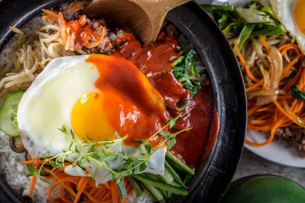 istock BI Bim Bap, Rice with Mixed Vegetables, top view with Hot Sauce in Cast Iron Pot 692403304