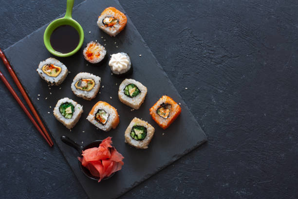 istock Set of  sushi rolls served on stone slate 692406664