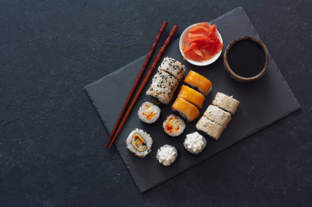 Set of  sushi rolls served on stone slate stock photo