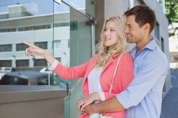 istock Stylish young couple window shopping 692409390