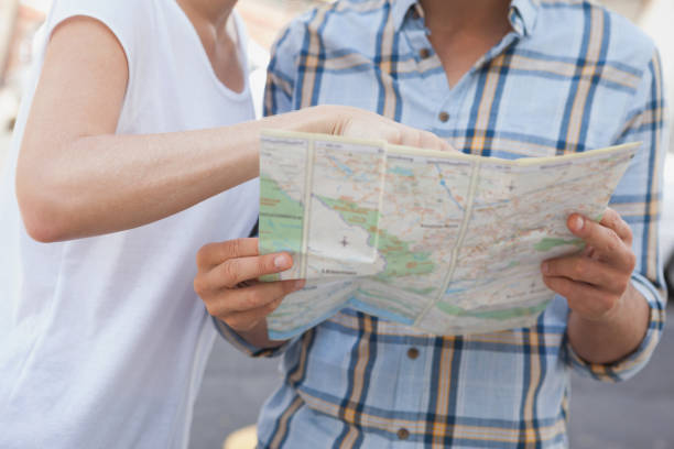 istock Young tourist couple looking at map 692409856