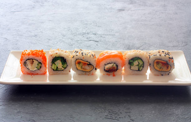 istock Set of  sushi rolls served on white plate 692412010