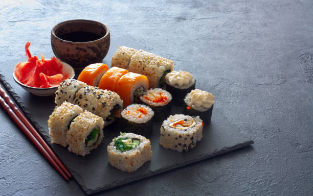 istock Set of  sushi rolls served on stone slate 692412678