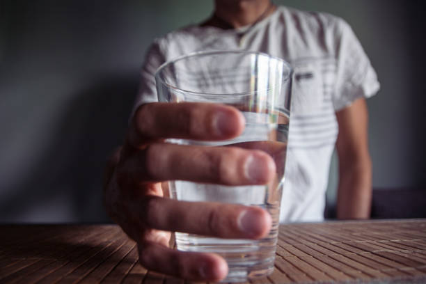 istock Man holding a glass of water 692412838