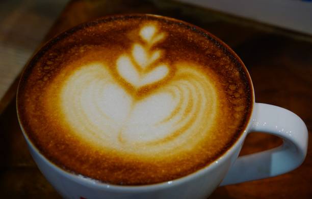 istock Cup of cafe' latte with coffee beans 692413438