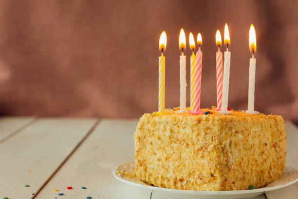 istock Birthday cake with candles on wooden table 692416330