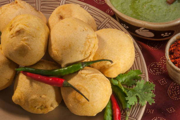 istock Batata Vada with garlic and mint chutney and chilli on white plate 692418932