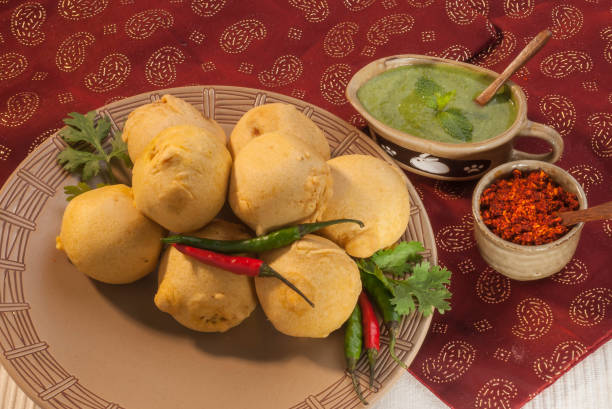 istock Batata Vada with garlic and mint chutney and chilli on white plate 692419078