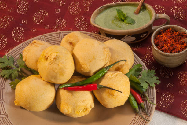 istock Batata Vada with garlic and mint chutney and chilli on white plate 692419124