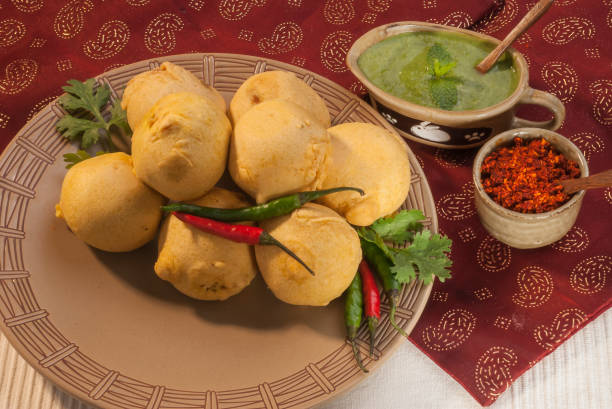 istock Batata Vada with garlic and mint chutney and chilli on white plate 692419128