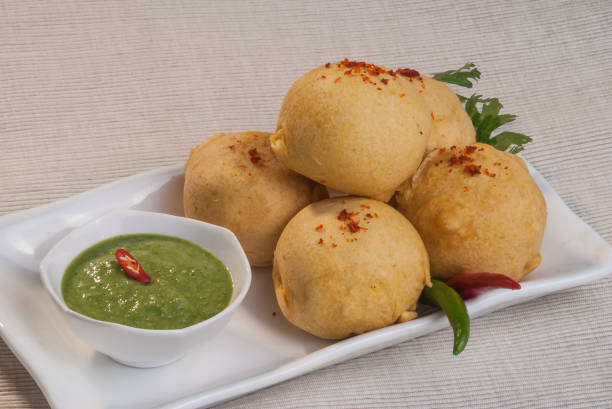 istock Batata Vada with garlic and mint chutney and chilli on white plate 692419198