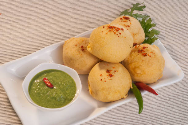 istock Batata Vada with garlic and mint chutney and chilli on white plate 692419218