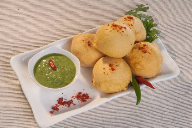 istock Batata Vada with garlic and mint chutney and chilli on white plate 692419222