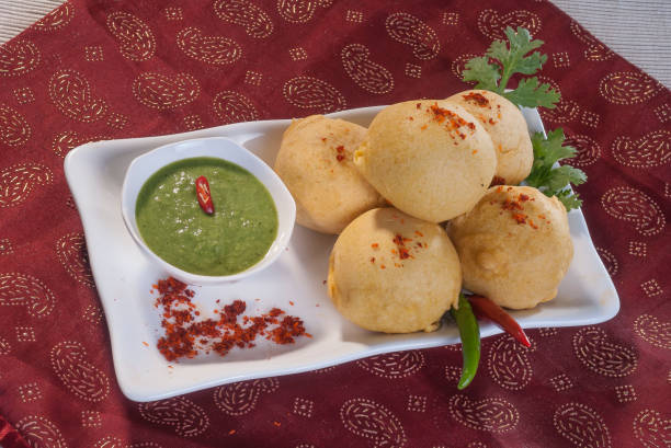 istock Batata Vada with garlic and mint chutney and chilli on white plate 692419236