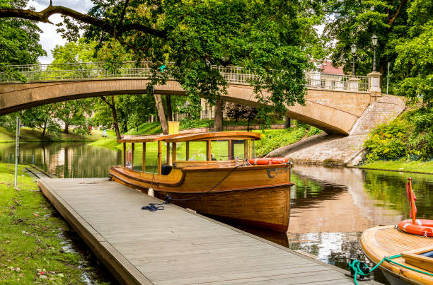 istock Pleasure boat docked at harbor in central park , Riga, Latvia 692422898
