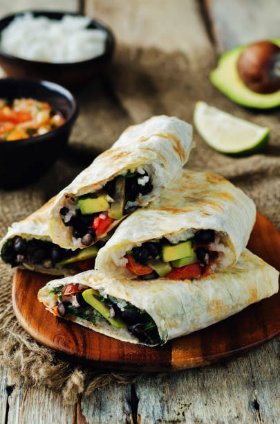 istock Rice black bean avocado tomato burritos 692423150