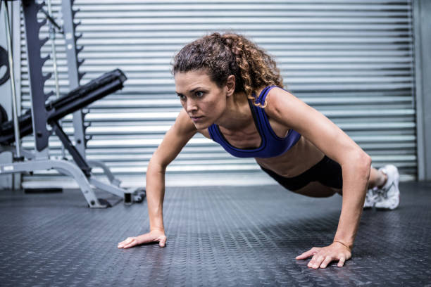 istock Muscular woman doing push-ups 692423634