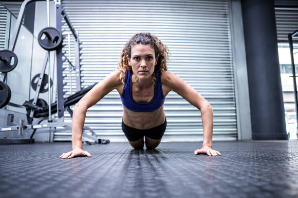istock Muscular woman doing push-ups 692425724