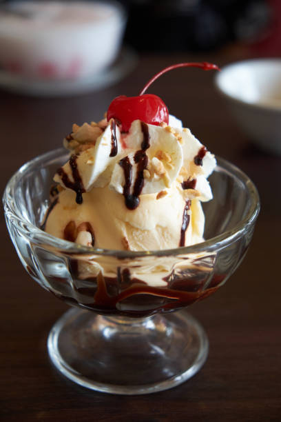 istock Ice cream chocolate and vanilla sundae topping with red cherry. 692426310