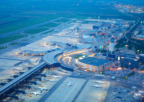 Rome, Italy - Feb 20, 2024:  The exterior and parking at the Fiumicino airport, Leonardo da VinciFiumicino Airport, Aeroporto di Roma, Fiumicino Leonardo da Vinci, and control tower.