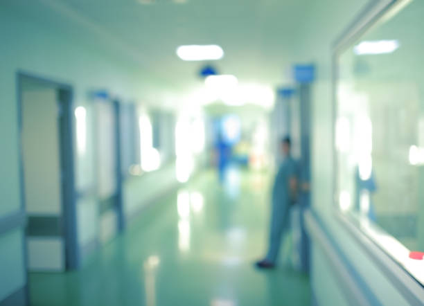 istock Workers silhouette in hospital corridor, unfocused background 692438504