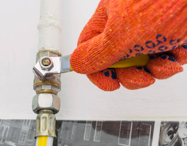 istock A gasman's hand in orange protective working gloves closes the gas valve. 692438694