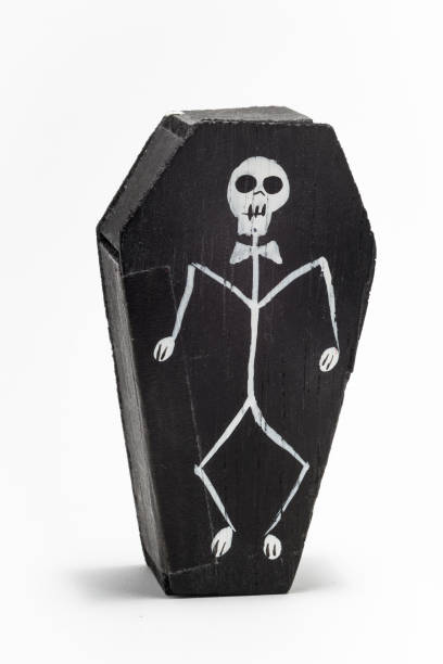 La Catrina in a small black wooden coffin with a skeleton on the front A mexican gift item celebrating the day of the dead that you might find in a tourist market or gift shop kachina doll photos stock pictures, royalty-free photos & images