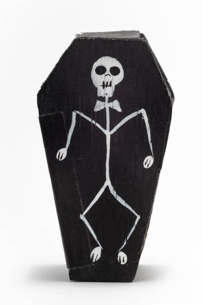 A black man carrying a skeleton on his back. Dark image.