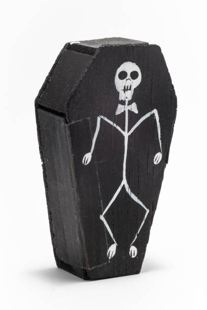 La Catrina in a small black wooden coffin with a skeleton on the front A mexican gift item celebrating the day of the dead that you might find in a tourist market or gift shop kachina doll stock pictures, royalty-free photos & images