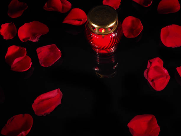 istock Burning candle in a red glass candlestick 692445324