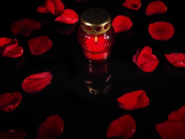 istock Burning candle in a red glass candlestick 692445372