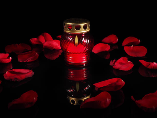istock Burning candle in a red glass candlestick 692445404
