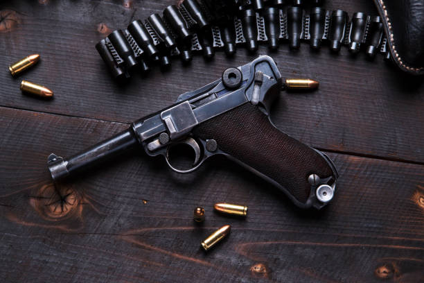 istock Gun Luger with cartridges and holster on the blackboard 692445794