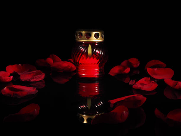 istock Burning candle in a red glass candlestick 692445942