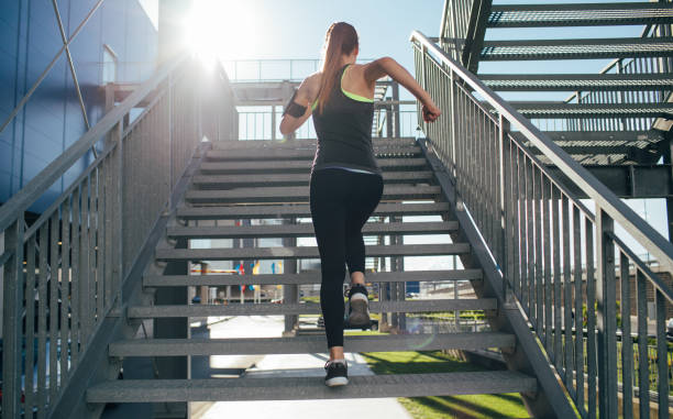 istock Woman running up a staircase 692446058