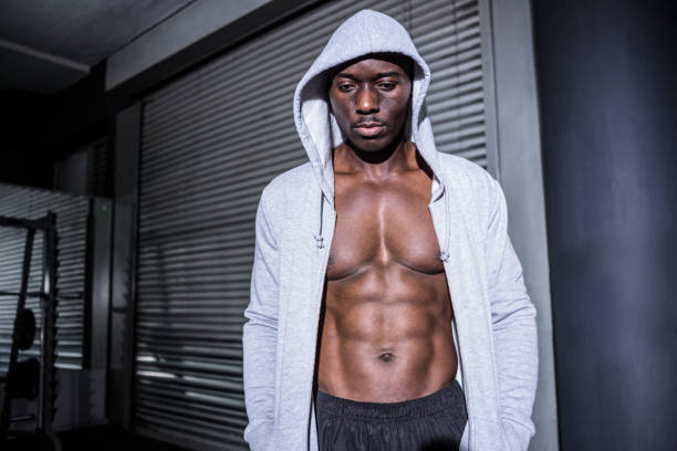 istock Young Bodybuilder in a hoodie looking at the ground 692449578