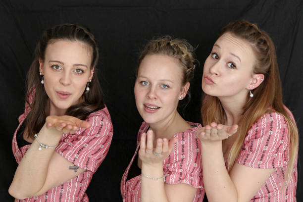 Three Swiss Sisters Sisters posing, showing happiness. kiss entertainment group stock pictures, royalty-free photos & images