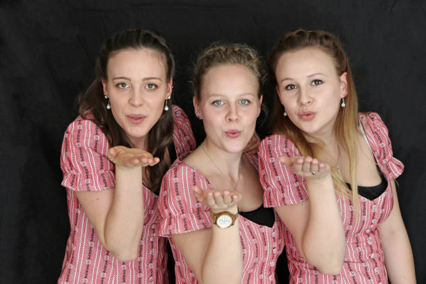 Three Swiss Sisters Sisters posing, showing happiness. kiss entertainment group stock pictures, royalty-free photos & images