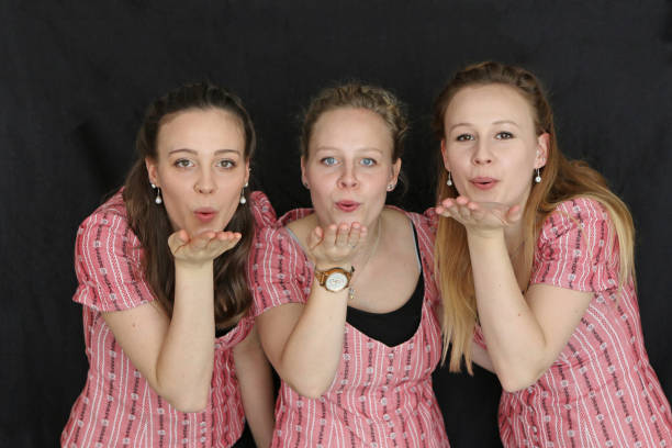 Three Swiss Sisters Sisters posing, showing happiness. kiss entertainment group stock pictures, royalty-free photos & images