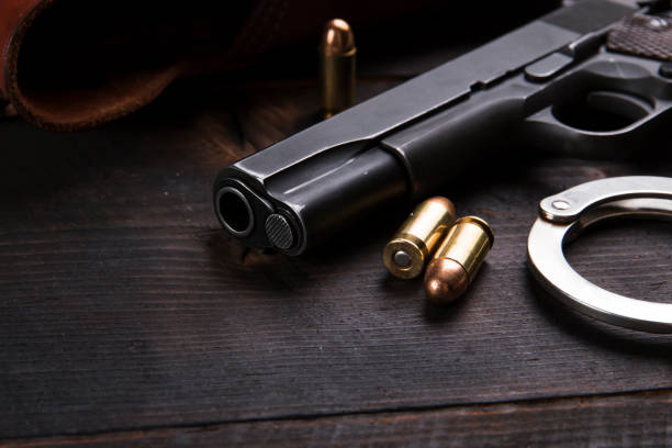 istock Gun Colt with bullets and holster rests on a leather jacket 692451790